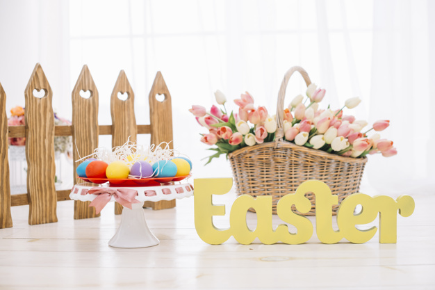 colorful-easter-eggs-tulips-basket-with-yellow-easter-text-wooden-desk_23-2148066250