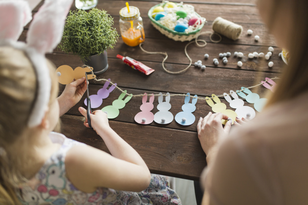 mother-daughter-cutting-bunnies-from-paper_23-2147760628